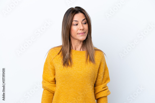 Middle age caucasian woman isolated on white background having doubts while looking side