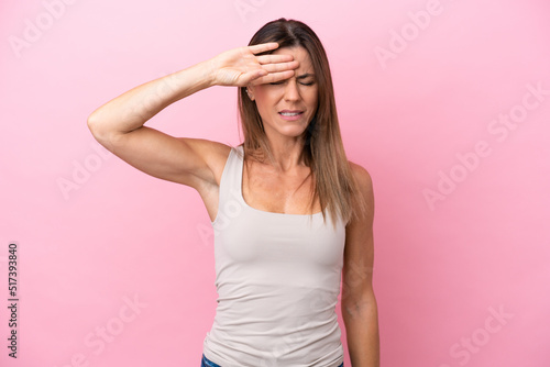 Middle age caucasian woman isolated on pink background with tired and sick expression