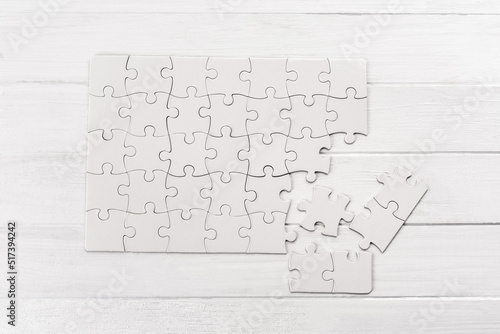 Small white puzzle sample on wooden table