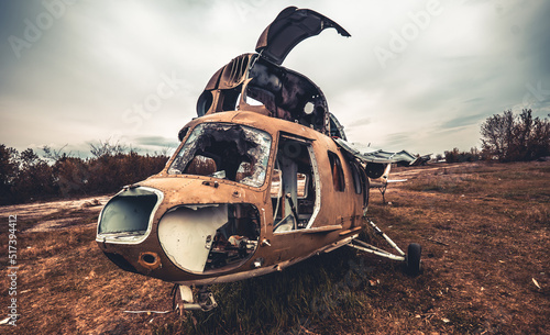Fotografie, Obraz Abandoned soviet union helicopter with camouflage color cabin at the airfield