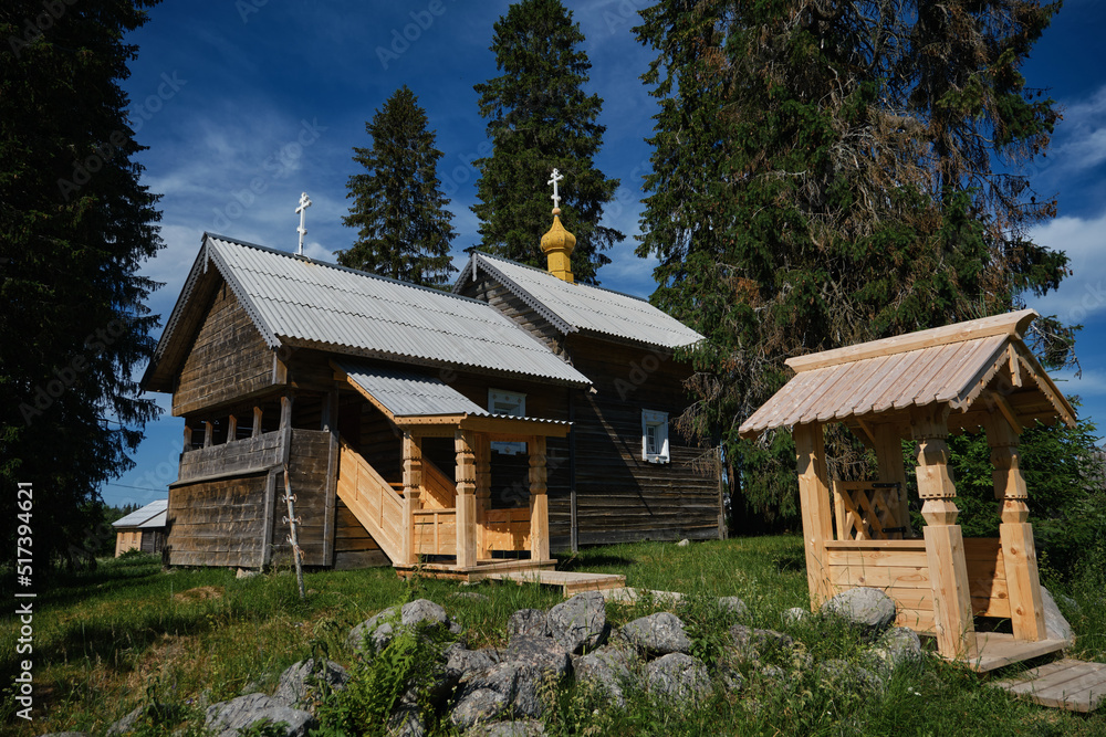 Obraz premium The concept of travel in Russia. One of the most beautiful villages of Karelia Kinerma in summer. The old wooden chapel temple with crosses on roof has been restored or well preserved to our time.