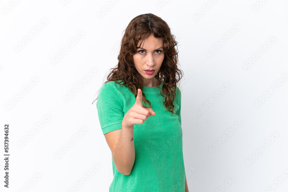 Young woman with curly hair isolated on white background frustrated and pointing to the front Young woman with curly hair isolated on white background frustrated and pointing to the front