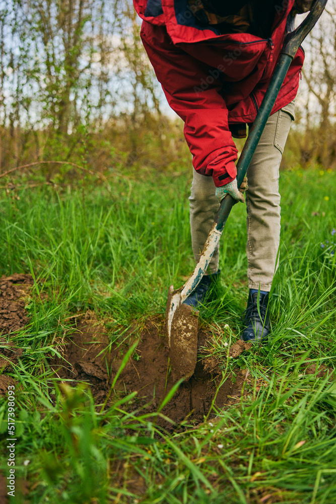 Female farmer digging ground in cloudy day. Woman working with shovel in field Female farmer digging ground in cloudy day. Woman working with shovel in field