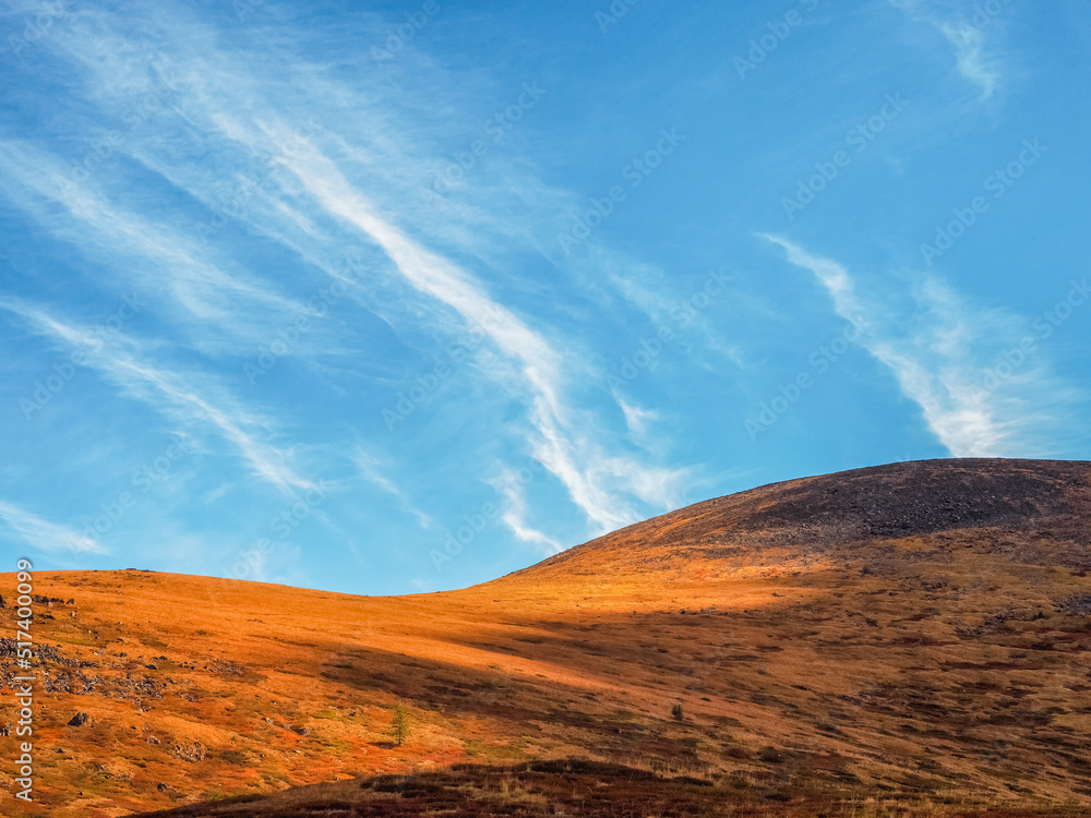 Fototapeta premium Minimalistic beautiful mountain scenery with golden light on slo