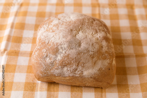 Fresh chabata bread on a yellow towel on a white background photo