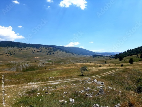 Landscape with gravel road, forest and clouds on mountain Bjelasnica, Bosnia and Herzegovina