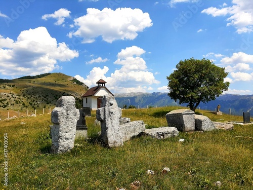 Old stone church with tombstones in Blace, mountain Bjelasnica, Bosnia and Herzegovina photo