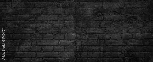 An old brick wall painted in black paint texture background