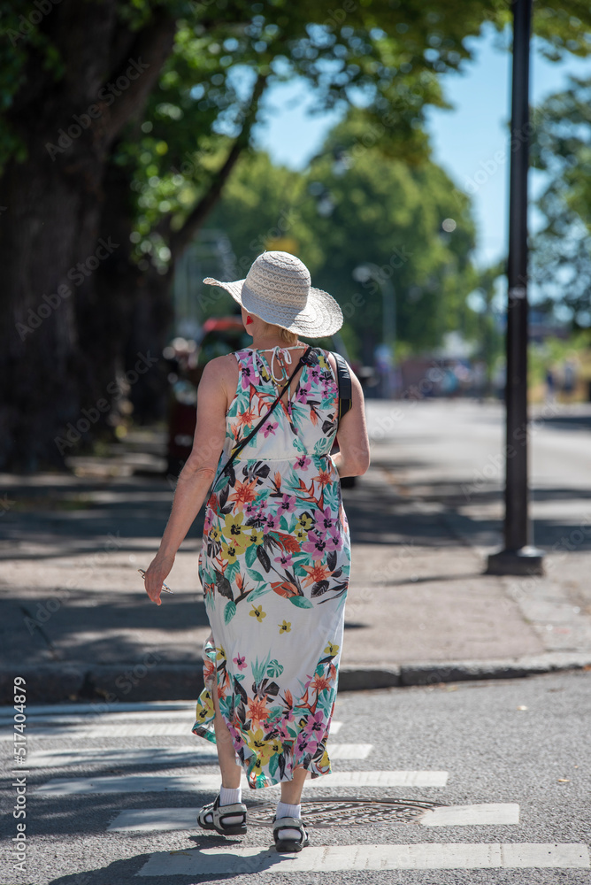 Woman walking on street in summer