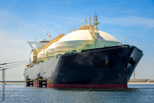 Low angle view of a large gas tanker ship in harbour on a clear summer day. Port of Rotterdam, Netherlands.