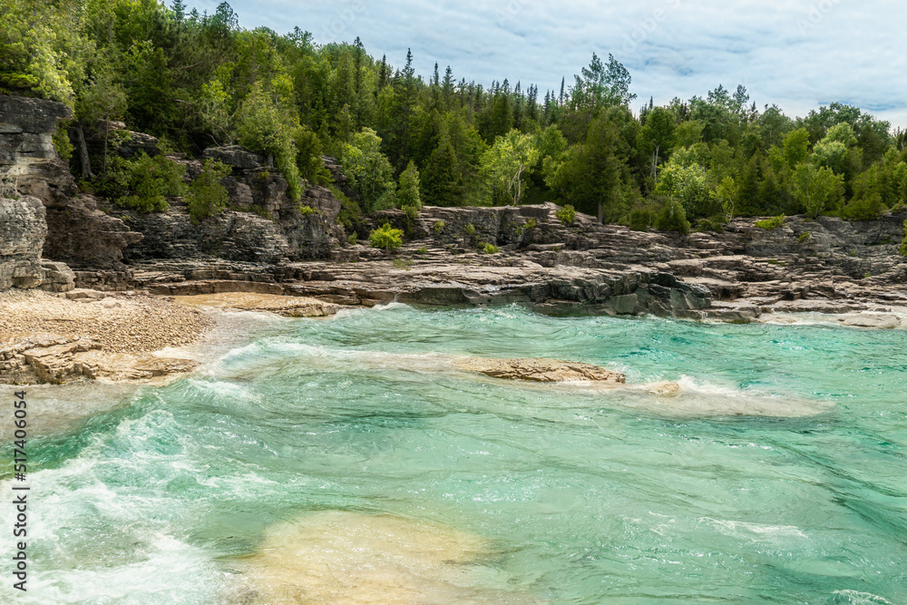 Indian Head Cove at Tobermory, turquoise blue water and green pine forest in Ontario Canada. Summer day at Bruce Peninsula National Park near Bruce trail, Georgian Bay Trail and Cyprus lake.