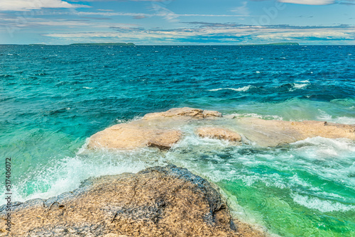 Colourful green waters at Indian Head Cove on lake Huron in Bruce Peninsula National Park and clear blue water in Ontario, Canada. Located between The Grotto and Overhanging rock tourist attractions. © desertsands