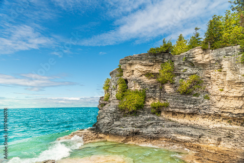 Panorama view of summer Georgian bay at Tobermory Ontario, Canada. Lake Huron and turquoise blue green transparent crystal clear water with rocky bottom formations. Indian Head Cove landscape. photo
