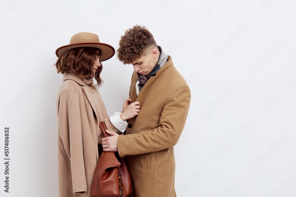 a happy couple is standing in autumn , stylish clothes and no need to hug each other looking at each other a happy couple is standing in autumn , stylish clothes and no need to hug each other looking at each other