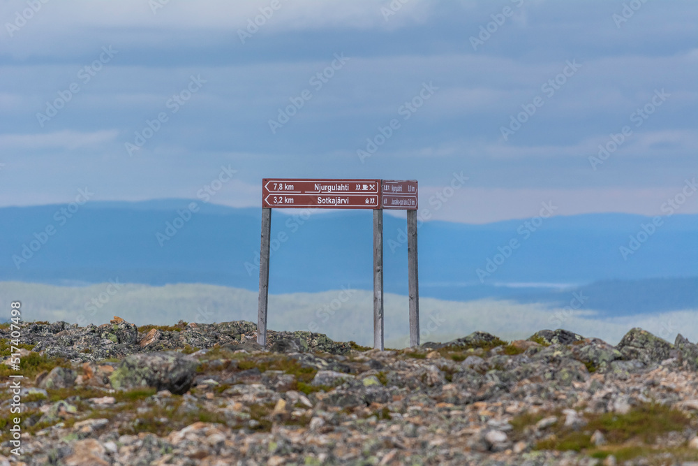 Signpost on the hiking trail in Lemmenjoki National Park in Finland.
