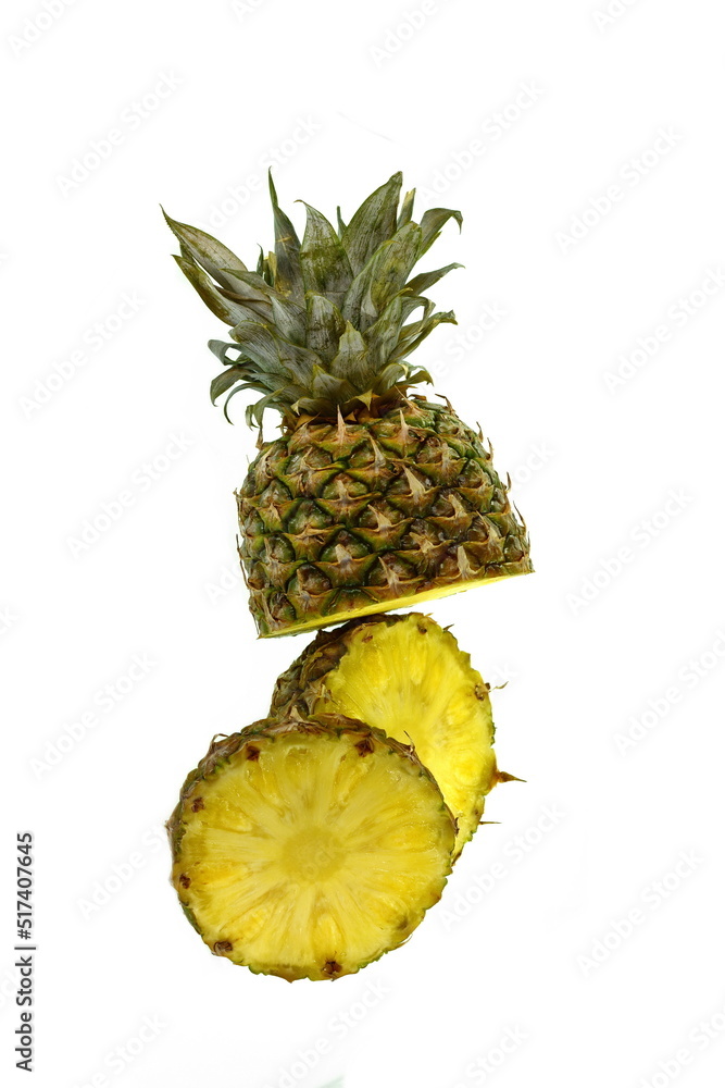 Whole pineapple and pineapple slice. Pineapple with leaves isolate on white. Full depth of field. Whole pineapple and pineapple slice. Pineapple with leaves isolate on white. Full depth of field.