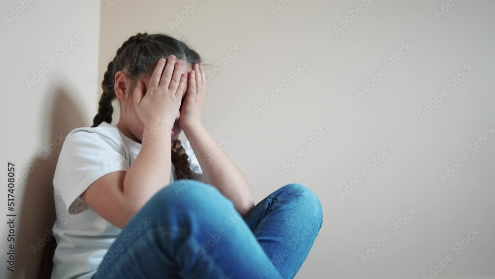 sad girl sitting in the corner lifestyle crying a covered her face with her hands. family violence abuse child concept. parents punished the child put in a corner. child in depression crying indoor sad girl sitting in the corner lifestyle crying a covered her face with her hands. family violence abuse child concept. parents punished the child put in a corner. child in depression crying indoor