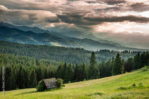 Cottage on green valley at sunset, Tatra mountains
