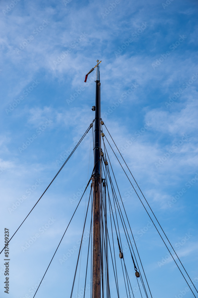 mast of a sailing ship against a blue sky mast of a sailing ship against a blue sky