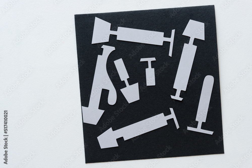 abstract paper shapes on black and white paper (clyster, syringe, weights, plungers, lamps or bully bat) abstract paper shapes on black and white paper (clyster, syringe, weights, plungers, lamps or bully bat)