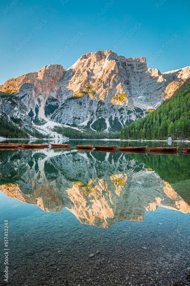 Wooden boats on calm Lago di Braies in Dolomites, Italy