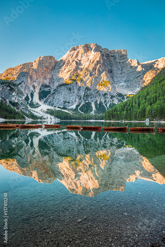 Wooden boats on calm Lago di Braies in Dolomites, Italy © shaiith