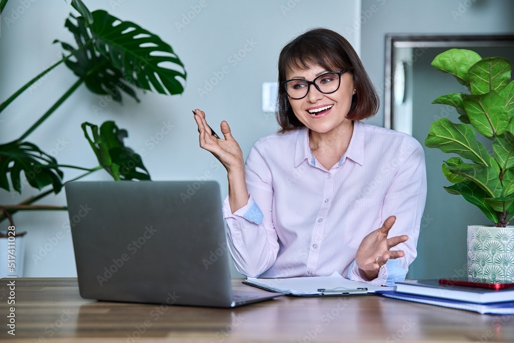 Mature woman using laptop for video call, virtual meeting Mature woman using laptop for video call, virtual meeting