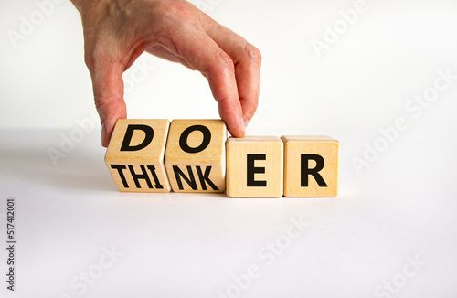 Doer or thinker symbol. Concept words Doer or thinker on wooden cubes. Businessman hand. Beautiful white table white background. Business and doer or thinker concept. Copy space.