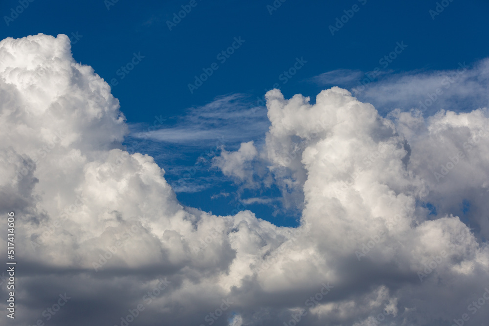 Beautiful fluffy white clouds in dramatic cloudscapes. Blue sky with contrasting puffy clouds. Monsoon clouds in the sky over the Sonoran Desert in Tucson, Arizona, USA. Beautiful fluffy white clouds in dramatic cloudscapes. Blue sky with contrasting puffy clouds. Monsoon clouds in the sky over the Sonoran Desert in Tucson, Arizona, USA.