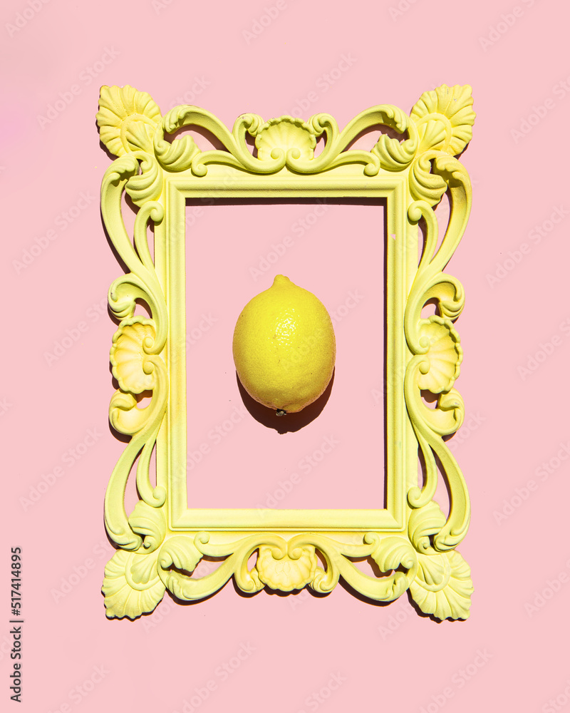 Vintage yellow frame and lemon on pastel light pink background