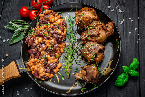 Braised beef tail in a pan with beans