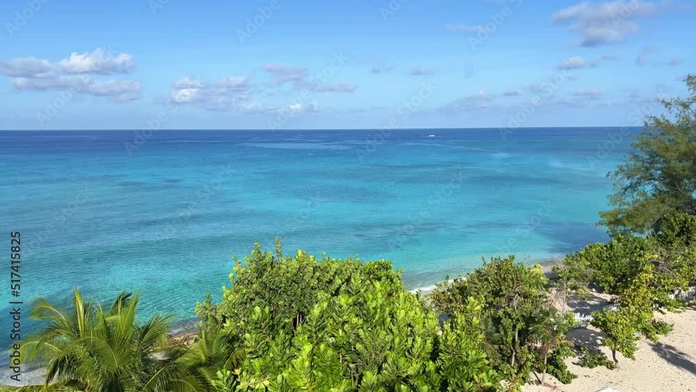 An aerial view of Cemetery Beach on Seven Mile Beach in Grand Cayman Island on a beautiful sunny day. An aerial view of Cemetery Beach on Seven Mile Beach in Grand Cayman Island on a beautiful sunny day.