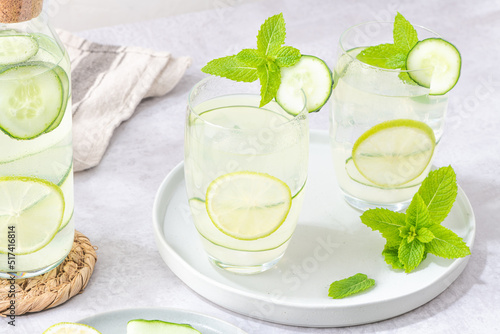 Refreshing infused water with cucumber, mint and lime. Summer drink cocktail lemonade. Healthy drink and detox concept