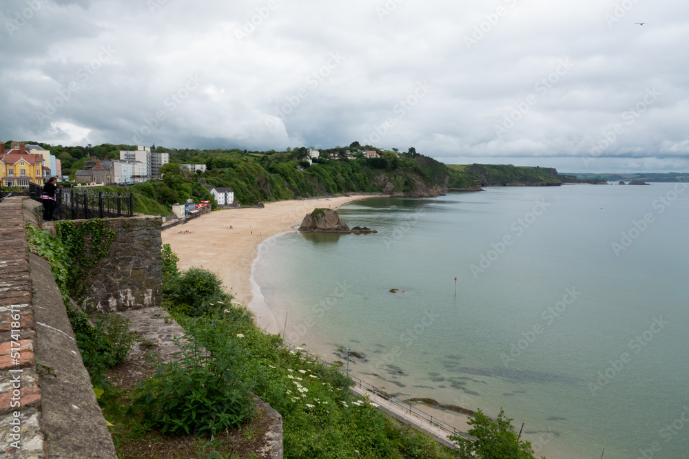 a view along a curving sandy beach