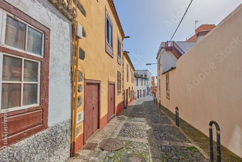 Historical city street view of residential houses in small and narrow alley or road in tropical Santa Cruz  La Palma  Spain. Village view of vibrant buildings in popular tourism destinations overseas