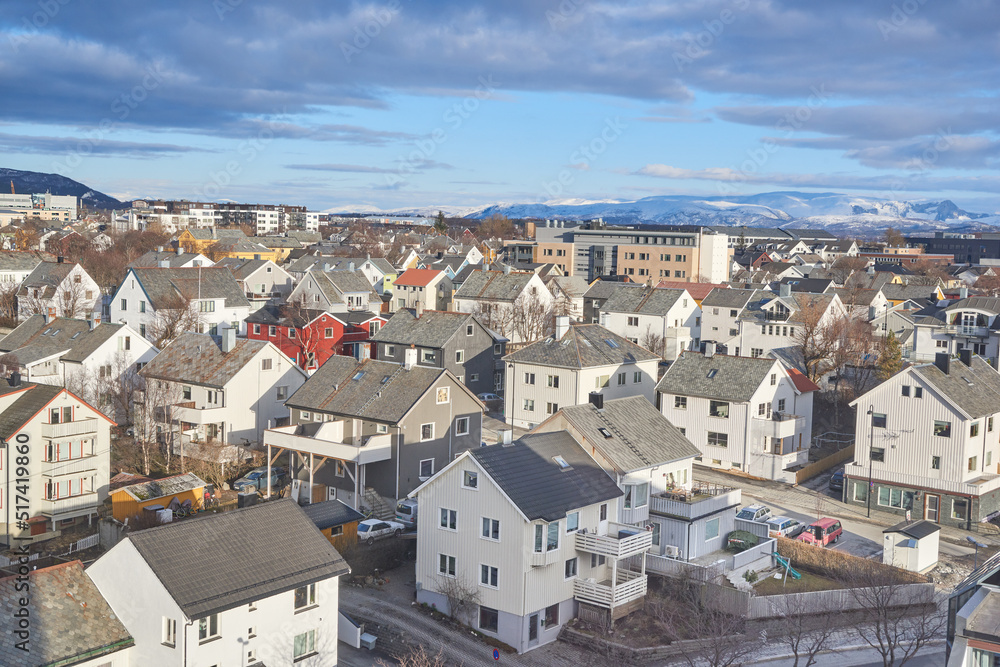 The small city of Bodo in Norway with a cloudy or overcast blue sky. A beautiful scenic view of urban landscape streets and buildings with copy space. Peaceful rural town from above