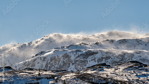 Scenic panoramic of snow capped mountain landscape in Bodo, Nordland, Norway against a clear blue sky background. Breathtaking and picturesque view of a cold and icy natural environment in winter photo