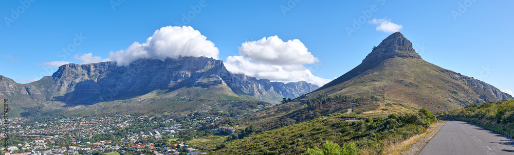 Copyspace with a mountain pass along Lions Head and Table Mountain in Cape Town, South Africa against a cloudy sky background over a peninsula. calm, scenic landscape to travel explore on a road trip