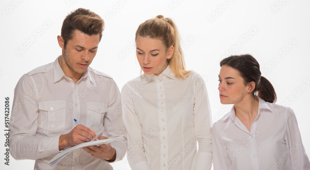 team of young business people in white shirts on a white background isolated. a team of two girls and a guy is happy, wins, plans, argues, discusses, gets upset, wins something. close-up portrait team of young business people in white shirts on a white background isolated. a team of two girls and a guy is happy, wins, plans, argues, discusses, gets upset, wins something. close-up portrait