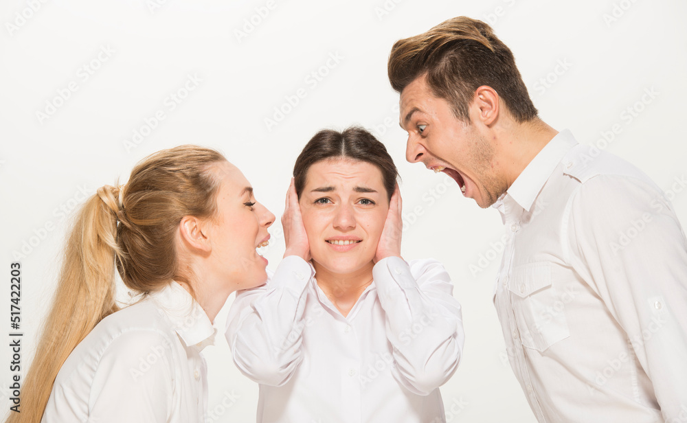 team of young business people in white shirts on a white background isolated. a team of two girls and a guy is happy, wins, plans, argues, discusses, gets upset, wins something. close-up portrait team of young business people in white shirts on a white background isolated. a team of two girls and a guy is happy, wins, plans, argues, discusses, gets upset, wins something. close-up portrait