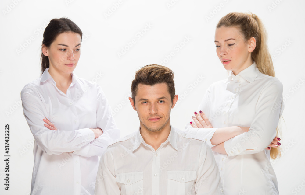 team of young business people in white shirts on a white background isolated. a team of two girls and a guy is happy, wins, plans, argues, discusses, gets upset, wins something. close-up portrait team of young business people in white shirts on a white background isolated. a team of two girls and a guy is happy, wins, plans, argues, discusses, gets upset, wins something. close-up portrait