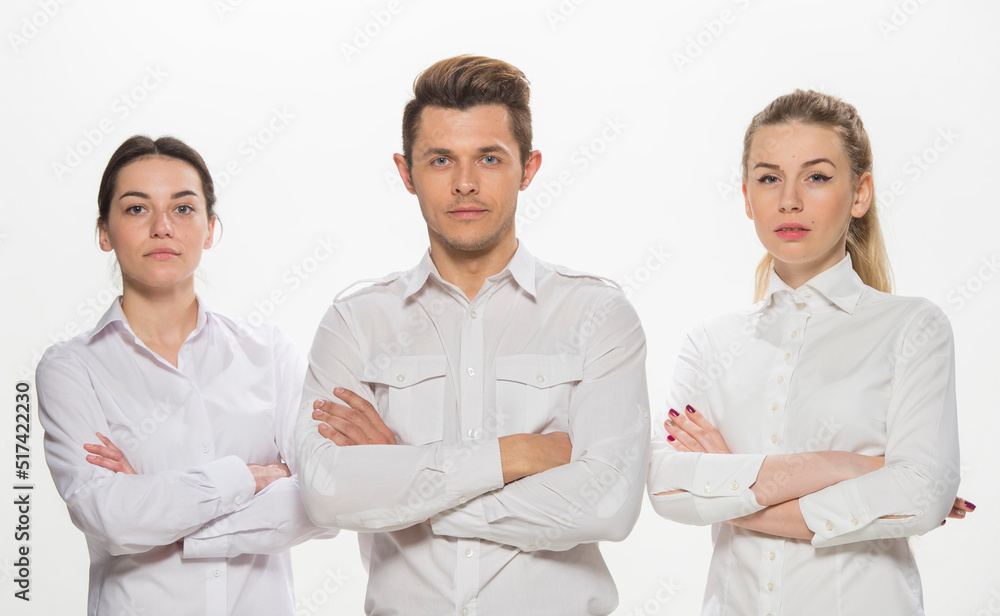 team of young business people in white shirts on a white background isolated. a team of two girls and a guy is happy, wins, plans, argues, discusses, gets upset, wins something. close-up portrait team of young business people in white shirts on a white background isolated. a team of two girls and a guy is happy, wins, plans, argues, discusses, gets upset, wins something. close-up portrait