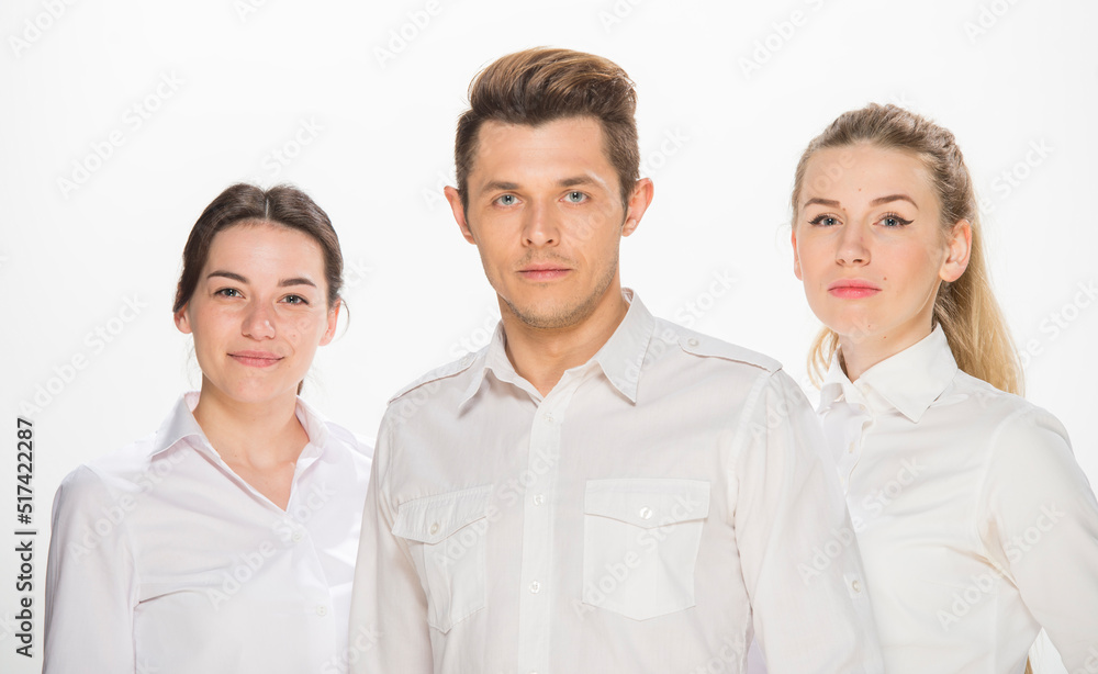 team of young business people in white shirts on a white background isolated. a team of two girls and a guy is happy, wins, plans, argues, discusses, gets upset, wins something. close-up portrait team of young business people in white shirts on a white background isolated. a team of two girls and a guy is happy, wins, plans, argues, discusses, gets upset, wins something. close-up portrait