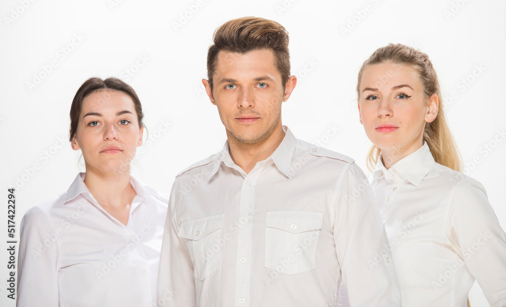team of young business people in white shirts on a white background isolated. a team of two girls and a guy is happy, wins, plans, argues, discusses, gets upset, wins something. close-up portrait team of young business people in white shirts on a white background isolated. a team of two girls and a guy is happy, wins, plans, argues, discusses, gets upset, wins something. close-up portrait