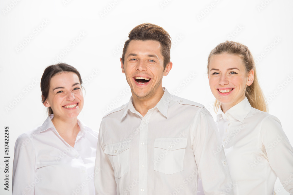 team of young business people in white shirts on a white background isolated. a team of two girls and a guy is happy, wins, plans, argues, discusses, gets upset, wins something. close-up portrait team of young business people in white shirts on a white background isolated. a team of two girls and a guy is happy, wins, plans, argues, discusses, gets upset, wins something. close-up portrait