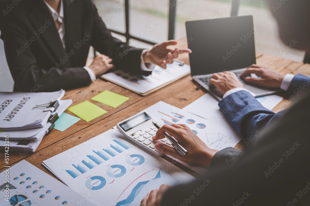 A business team consultant describes a marketing plan to set business strategies for business owners using a calculator. business planning and business researching concept. A business team consultant describes a marketing plan to set business strategies for business owners using a calculator. business planning and business researching concept.