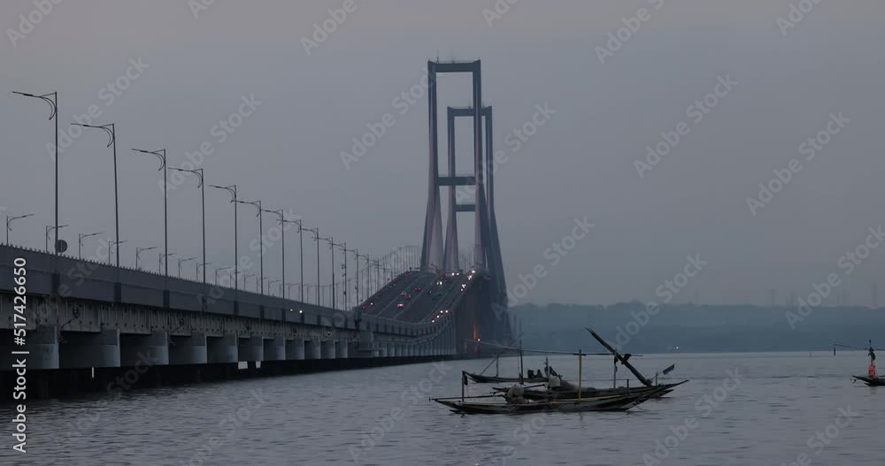 Fishing boats in the Java Sea pass under the Suramadu Bridge which is the longest bridge in Indonesia and the link between the islands of Java and Madura. Fishing boats in the Java Sea pass under the Suramadu Bridge which is the longest bridge in Indonesia and the link between the islands of Java and Madura.