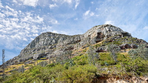 Landscape view of Lions Head and its natural surroundings in summer. Scenic view of a popular natural landmark in Cape Town, South Africa against a cloudy blue sky. Travel destination for tourists