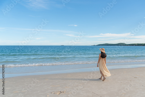 The lonely woman walk slowly to relax at the beach at holiday