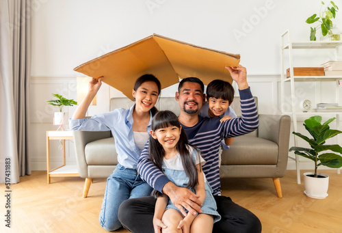 Young Asian family. mother father and children in new home.Family New Home Moving Day House.
